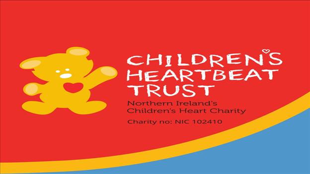 Picture of teddybear with childrens heartbeat trust beside it on red and blue background